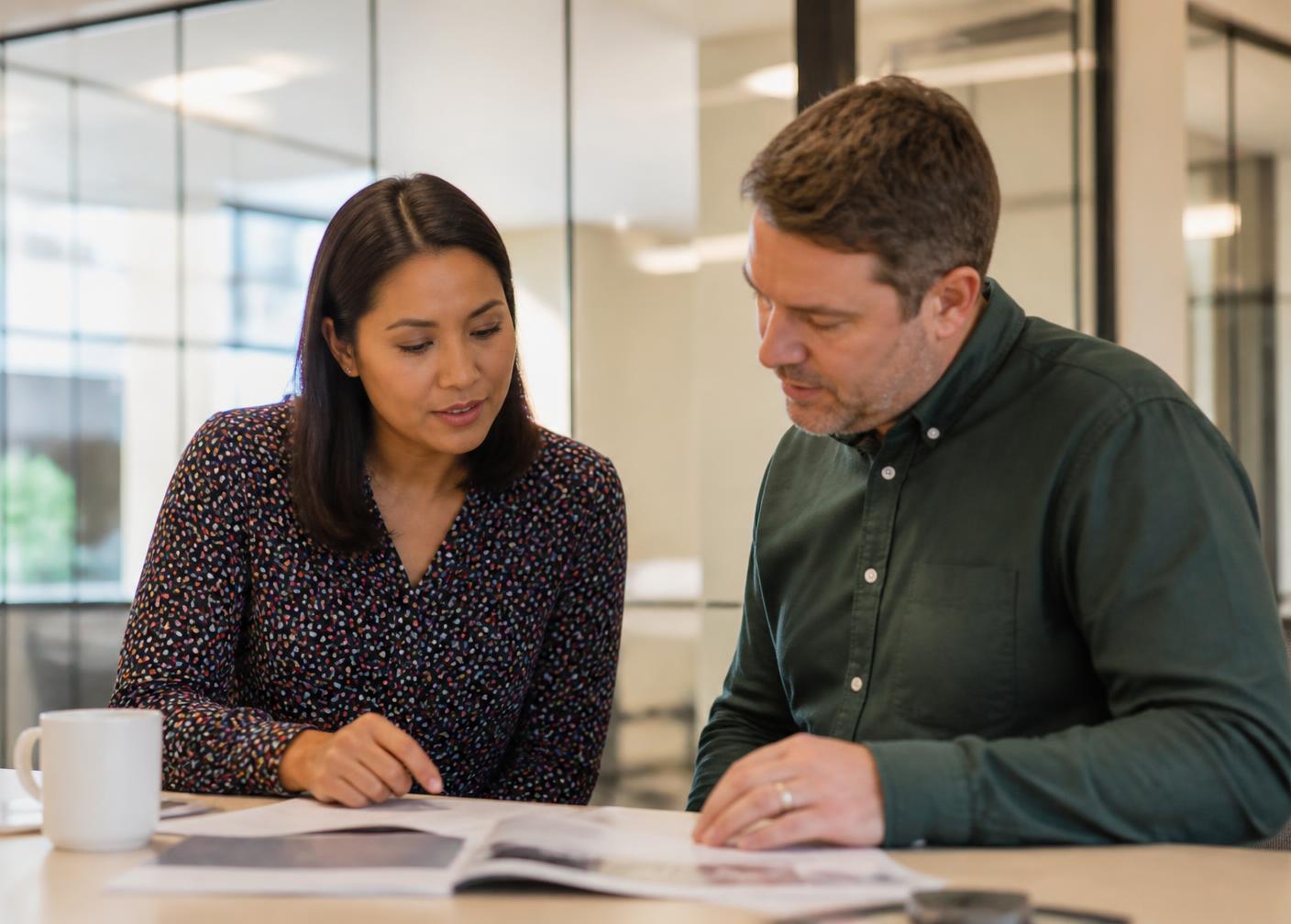 Two insurance professionals reviewing motor carrier information together
